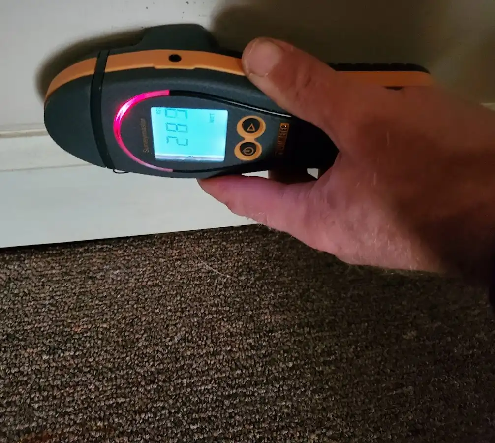 Moisture detection at baseboard during Storm Damage Restoration in Charlotte